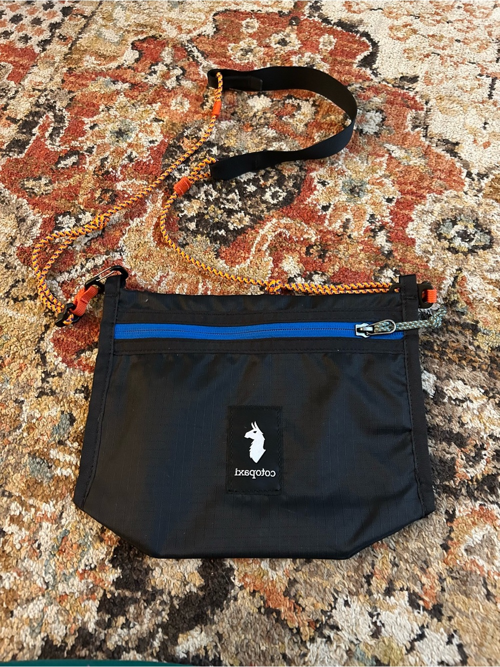 Cotopaxi Black Crossbody Pack with Blue Zip